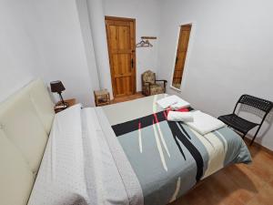 1 dormitorio con 1 cama y 1 silla en Corralazo A, en Calasparra