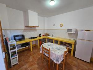 a kitchen with a desk and a table and a refrigerator at Corralazo A in Calasparra