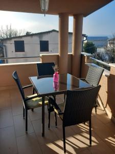 a table and chairs on a balcony with a view at Čalić in Seline +19 photos