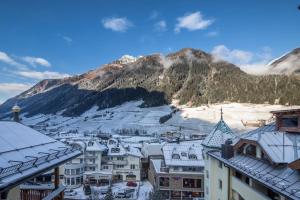 a view of a town with a mountain in the background at Superior Hotel Post Ischgl in Ischgl