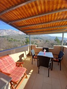 a patio with a table and chairs and a view at Čalić in Seline
