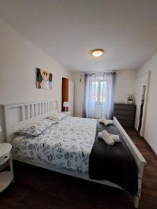 a bedroom with a large bed and a window at Apartman Darija in Pazin