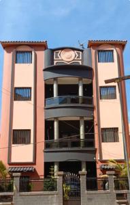 a large building with a clock on the side of it at Cabral résidence in Guediawaye