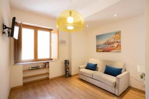a living room with a couch and a window at Amalfi e Positano Home in Salerno