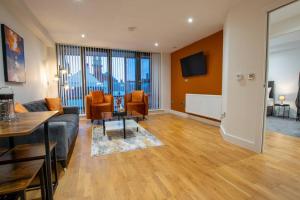 a living room with a couch and a table and chairs at Luxury City Centre Apartment (Weekly Booking) in Hull