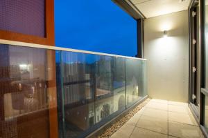 a balcony with a view of a city skyline at Luxury City Centre Apartment (Weekly Booking) in Hull