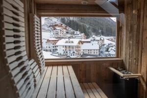 a window with a view of a snowy mountain at Superior Hotel Post Ischgl in Ischgl