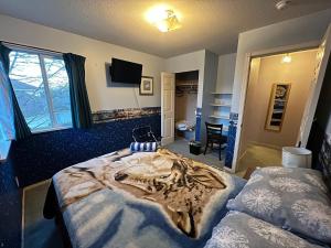 1 dormitorio con 1 cama grande con manta de lobo en Anita's Bed & Breakfast - Bedroom On Ground Floor With Backyard, en Abbotsford