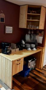 a kitchen with a wooden counter with dishes on it at Gîte Au p'tit bonheur B&B in Coaticook