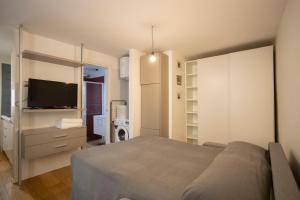 Schlafzimmer mit einem Bett und einem Flachbild-TV in der Unterkunft Domo House in Salerno