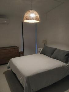 a bedroom with a bed and a pendant light at Casa 4 amb y cochera Don Bosco in Córdoba