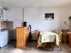 a kitchen with a table and a table and chairs at Résidence Soldanelles - 2 Pièces pour 6 Personnes 21 in Peisey-Nancroix