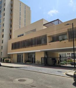 a large building on the side of a street at Apartamento encanto urbano. in Barranquilla