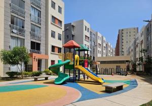 a playground with a slide and benches in a city at Apartamento encanto urbano. in Barranquilla