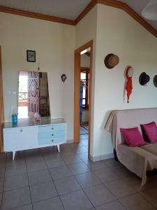 a bedroom with a bed and a dresser with pink pillows at Villa Anta in Skala Kallirakhis