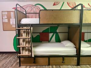 two bunk beds in a room with a mural at RAD Hostel in Colorado Springs