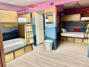 a room with two bunk beds and a room with a room at RAD Hostel in Colorado Springs