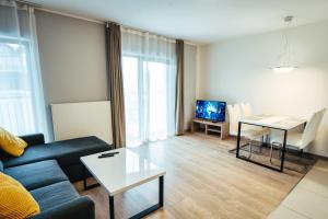 Televízia a/alebo spoločenská miestnosť v ubytovaní Apartament 19 Szklarska Poręba