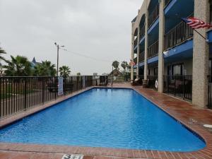 a large blue swimming pool in front of a building at Krsna's Castle (Hunt's Castle) in Rockport