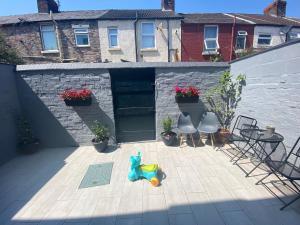 a patio with two chairs and a toy on it at Cozy Retreat Haven in Liverpool