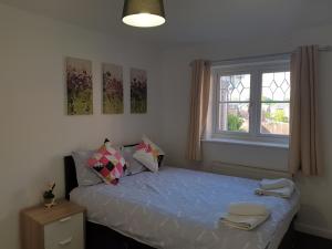 a bedroom with a bed with two towels on it at Perfect Stay Manchester in Wythenshawe
