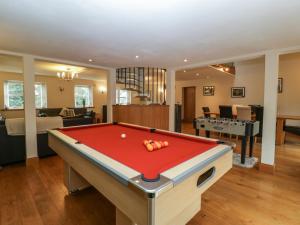 a living room with a pool table in it at About Time Cottage in Lydney