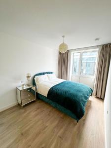 a bedroom with a large bed and a window at Elegant 2 Bedroom Apartment in Grand Canal in Dublin