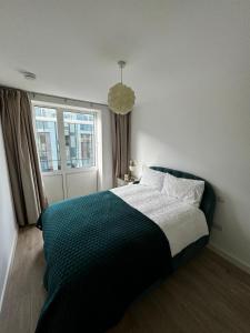 a bedroom with a bed and a window at Elegant 2 Bedroom Apartment in Grand Canal in Dublin