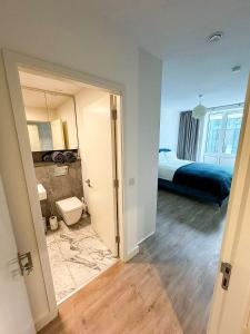 a bathroom with a bed and a toilet in a room at Elegant 2 Bedroom Apartment in Grand Canal in Dublin