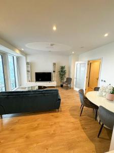 a living room with a couch and a table at Elegant 2 Bedroom Apartment in Grand Canal in Dublin