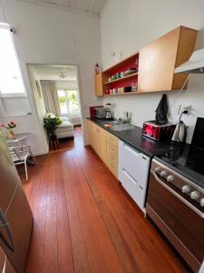 a kitchen with wooden floors and a counter top at Grey Lynn House Auckland in Auckland