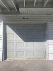 a garage door with the number on it at Luv Happii House in Country Club Hills