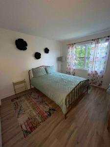 a bedroom with a bed and a window at Luv Happii House in Country Club Hills
