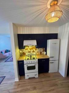 a kitchen with a white stove and a refrigerator at Luv Happii House in Country Club Hills