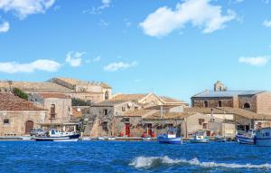 a group of boats are docked in a harbor at Nice Apartment In Marzamemi in Marzamemi