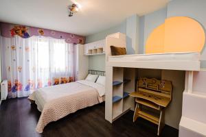 a childs bedroom with a bunk bed and a desk at Spacious apartment close to Valea Trandafirelor park! in Chişinău