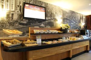 アムステルダムにあるバスティオン ホテル アムステルダム ツィドヴェスのパンとペストリーのビュッフェを提供するベーカリー