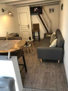 een woonkamer met een bank en een tafel bij petit maison Indépendant ile oleron sans ext in Grand-Village-Plage