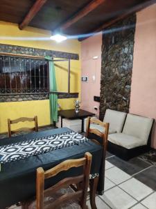 a room with a bed and a couch and a table at La Posada del Norte in La Rioja