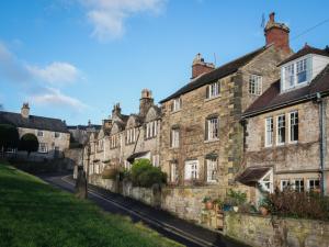 a row of old stone buildings on a street at Bakewell cottage in Bakewell