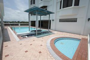 a swimming pool in the middle of a building at Parkview Hotel in Kampong Jerudong