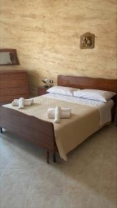 a bedroom with a bed with towels on it at appartamento NONNA ROSA in Morano Calabro