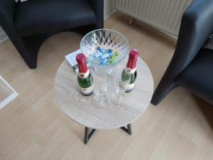 a table with two bottles and glasses on it at Benjamin 1 in Plauen