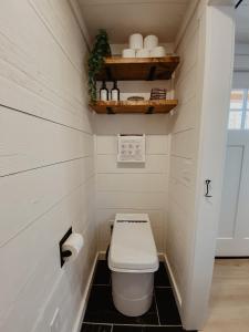 a bathroom with a toilet in a small room at Shipping Container Home near Fall Creek Falls State Park in Dunlap