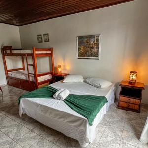 a bedroom with two beds and a bunk bed at Pousada My House Arraial do Cabo in Arraial do Cabo