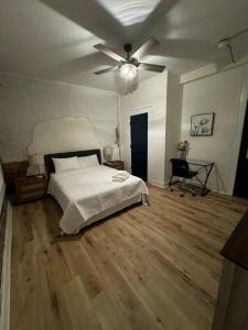 a bedroom with a bed and a ceiling fan at Historic Hideout in Fayetteville