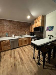 a kitchen with wooden cabinets and a table in it at Historic Hideout in Fayetteville