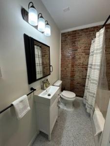 a bathroom with a sink and a toilet and a shower at Historic Hideout in Fayetteville