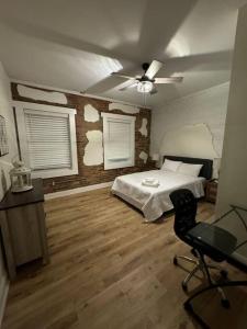 a bedroom with a bed and a ceiling fan at Historic Hideout in Fayetteville