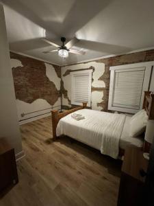 a bedroom with a bed and a brick wall at Historic Hideout in Fayetteville